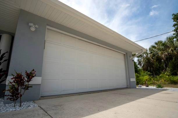 white garage door outdoor view with grey walled house -repair garage door