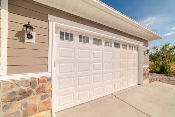 white garage door outdoor view with brown house and blue sky -emergency garage door repair