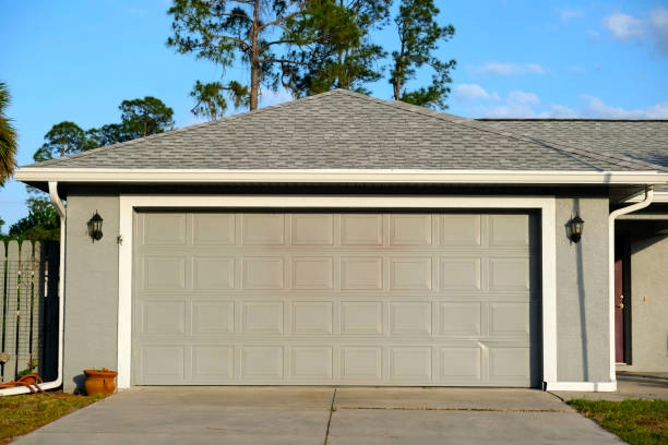 grey garage door, grey wall, grey bricked roof outdoor view -repair garage doors