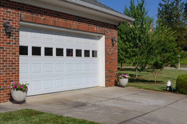 white garage door with glass windows outside view with bricked wall -garage door repair cost