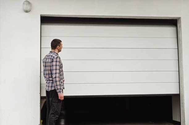 outdoor view of white garage door with person standing -garage door cost and installation