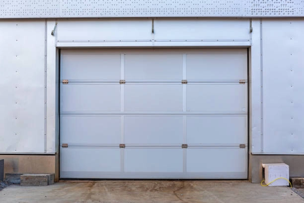 Gray industrial garage door with a minimalistic, modern appearance. -garage door covers