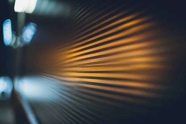 Blurred close-up of a metallic surface with streaks of warm light. -garage door covers